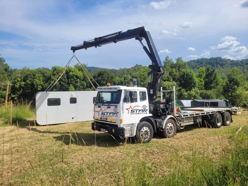 Iveco crane truck lifting a cabin